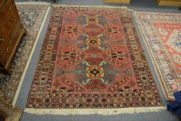 A Persian design rug with pink ground with stylised floral decoration 190cm x 140cm.