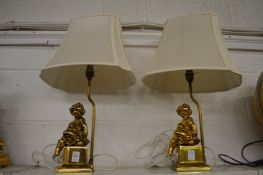 A pair of decorative gilt metal figural table lamps.