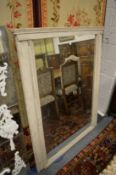 A large over mantel mirror with painted frame.