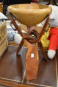 An African hardwood bowl on folding stand.