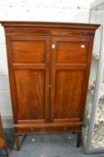 A mahogany cupboard with two doors and one long drawer.