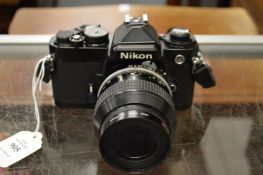 A Nikon 35mm camera with lens.