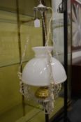 A white painted cast metal hanging lantern with opaque glass shade.