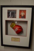 Boxing interest, a signed Sir Henry Cooper boxing glove, framed and glazed with associated
