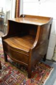 A George III mahogany commode with rising top, lifting seat on square legs.