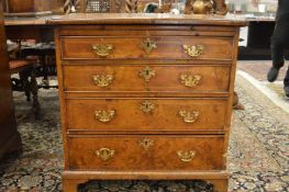 An 18th century walnut chest of four long graduated drawers.