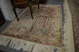 A small cream ground tree of life style rug 130cm x 94cm.