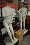 Two adjustable mannequins on stand.