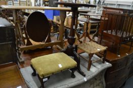 A mahogany tripod table and two stools.