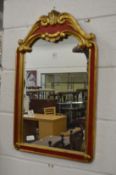 A decorative gilt wood and red painted wall mirror.