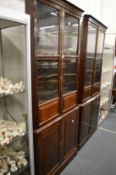 A good pair of mahogany standing corner cabinets, one 19th century the other later, both with glazed