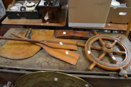 A small teak and brass ships wheel and other nautical items.