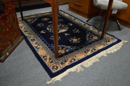 A Chinese rug, blue ground with floral decoration 180cm x 125cm.