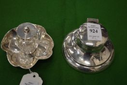 Two silver ink wells.