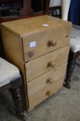A small pine four drawer chest.