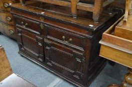 An 18th century oak chest with a single long drawer above a pair of geometrically panelled doors.