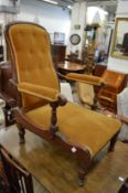 A Victorian mahogany Campaign armchair with folding back, arms and legs.