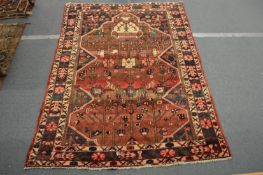 A Persian carpet with all over stylised decoration 280cm x 206cm.
