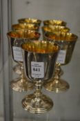 A set of seven silver goblets.