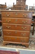 A George III oak straight front chest of five graduated long drawers.