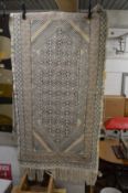 An ethnic tapestry style rug 195cm x 102cm.