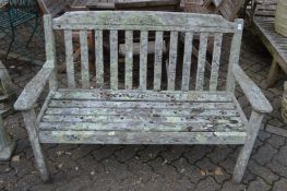 A weathered hardwood garden bench.