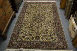 A Persian rug, beige ground with all over floral decoration 225cm x 140cm.