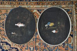 A pair of oval paintings on fabric, unframed.