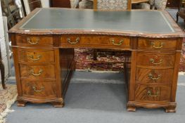 A good George III design mahogany partners desk with shaped top on pedestal supports with carved