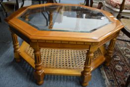 An octagonal shaped two tier glass top coffee table.