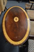 An inlaid mahogany oval occasional table.