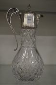 A cut glass and silver mounted claret jug.