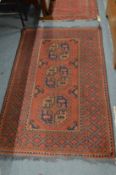 A Persian design rug, red ground with three large central medallions 167cm x 100cm.