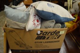 Box of decorative cushions.