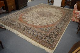 A good large Persian design carpet, cream ground with stylised floral decoration within similar