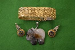 Gilt metal bracelet, a pair of decorative ear clips and hardstone pendant modelled as a horse.