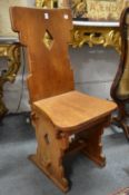 A pair of Arts and Crafts Gothic Revival walnut side chairs.