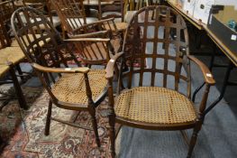 James Shoolbred, a pair of unusual beech framed lattice back and cane work seated armchairs (applied