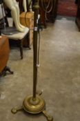 A brass floor standing lamp.