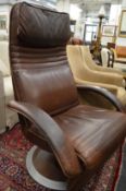 A stylish brown leather upholstered swivel armchair.