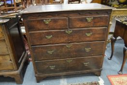 A George III oak straight front chest of two short and three graduated long drawers.