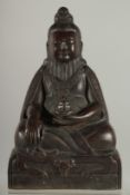 A FINE TIBETAN BRONZE FIGURE OF LAMA TROPTE TUNGDEN DJABO, with long beard and hair gathered in a