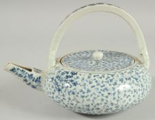 A JAPANESE BLUE AND WHITE PORCELAIN TEAPOT, with foliate decoration.