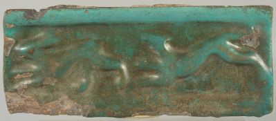 A RARE 13TH CENTURY PERSIAN SELJUK KASHAN TURQUOISE GLAZED POTTERY TILE, with relief animal designs,