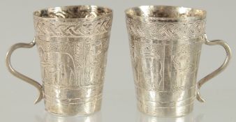 TWO SMALL ETHIOPIAN SILVER CUPS, with engraved decoration, 4.5cm high.