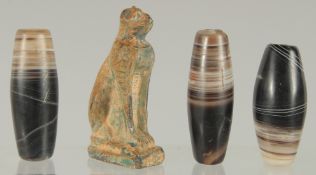 AN EGYPTIAN CARVED STONE CAT, together with three large banded agate beads, (4).
