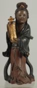 A LACQUERED AND GILDED CARVED WOODEN FIGURE, of Guanyin holding an urn, 17cm high.