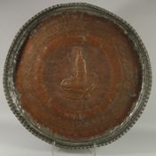 A VERY LARGE AND UNUSUAL 19TH CENTURY OMANI TINNED COPPER TRAY, with central jambiya dagger, 75cm