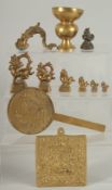 A COLLECTION OF SEVEN BRASS OPIUM WEIGHTS, together with four other brass items, (11).