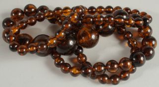 A LARGE BEADED NECKLACE, with graduating beads.